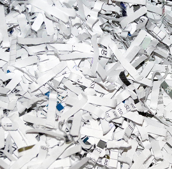 A close-up of a pile of shredded paper showcases the meticulous work of Confidential Paper Shredding Services.